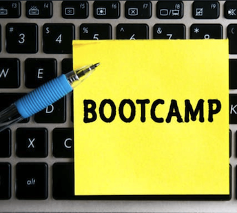 Image of yellow post-it on top of a computer keyboard with the word "Bootcamp" written on it.